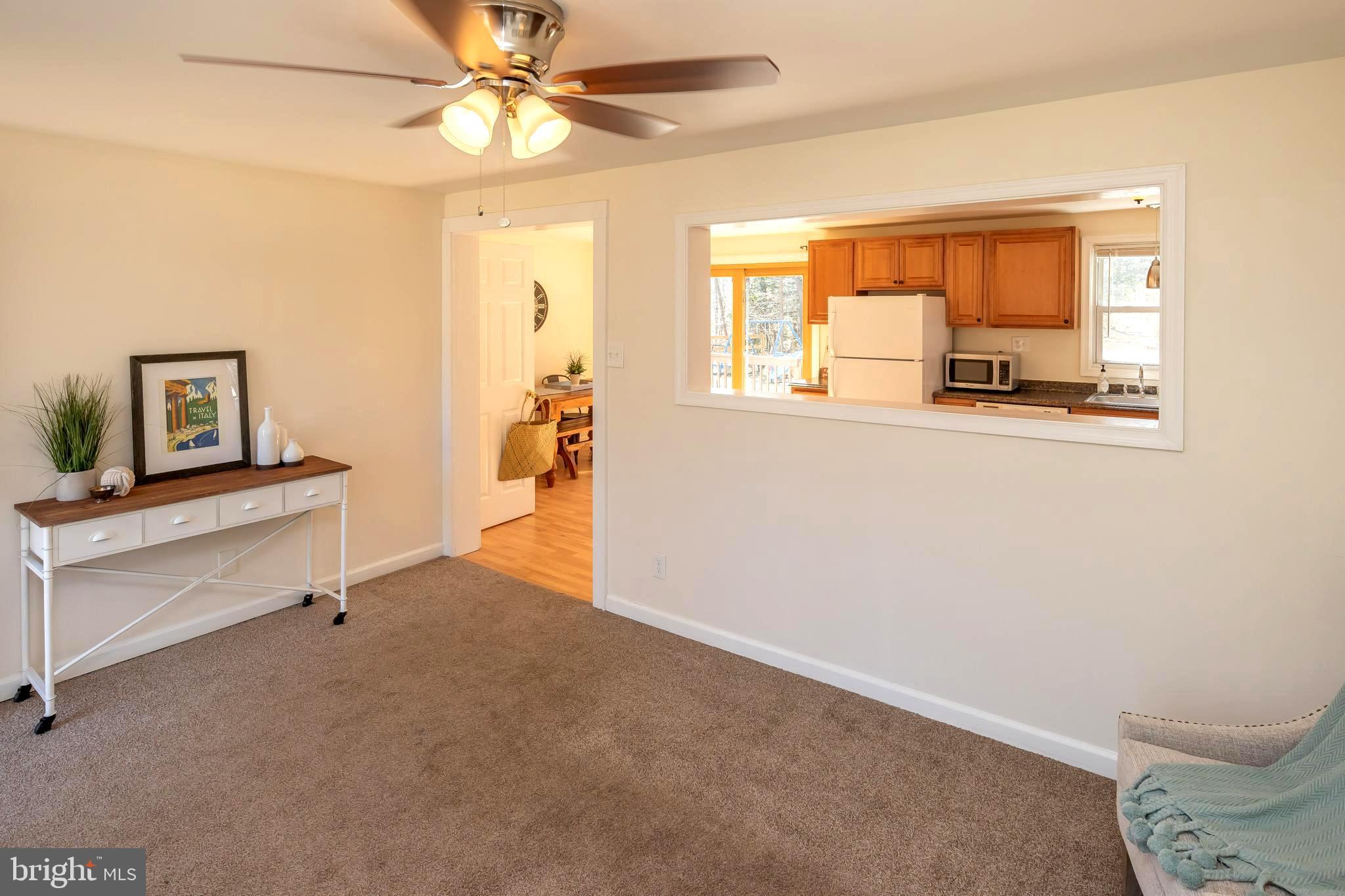 949 Hilltop Road Arnold, MD 21012 - Photo 14 of 42 Quality Neutral Carpet . Window Cutout to Kitchen