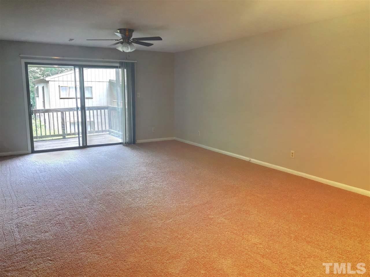 5086 Flint Ridge Place, Unit 5086 Raleigh, NC 27609 - Photo 4 of 8 wooden floor in an empty room with a window