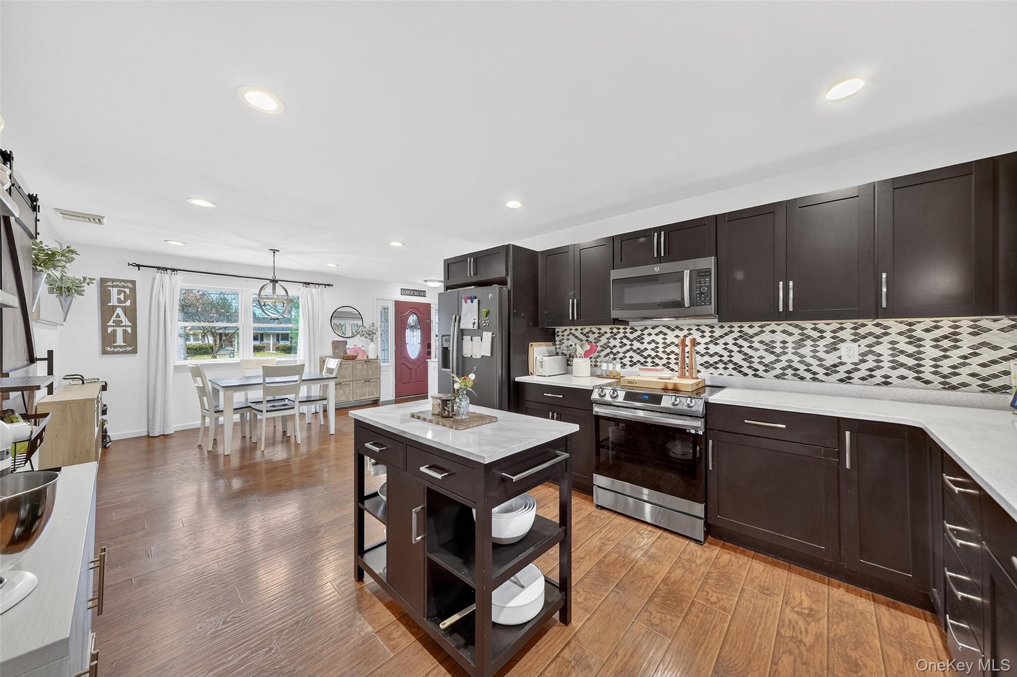 8 Ridge Road Wallkill, NY 12589 - Photo 15 of 48 a kitchen with stainless steel appliances kitchen island granite countertop a stove refrigerator and cabinets
