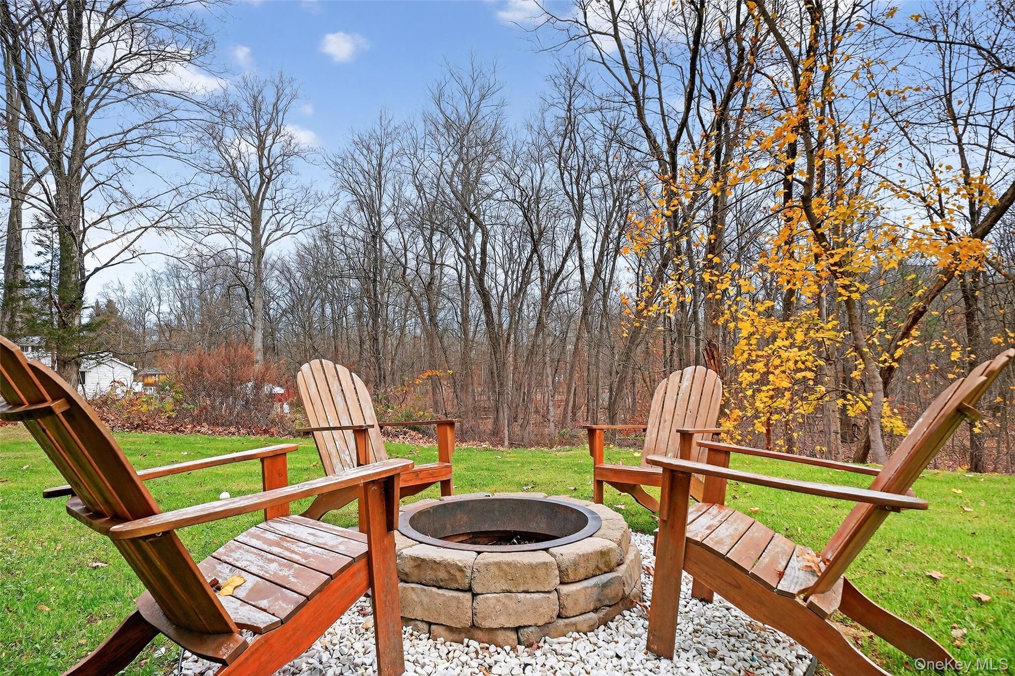 8 Ridge Road Wallkill, NY 12589 - Photo 46 of 48 a view of a chair and tables in the backyard