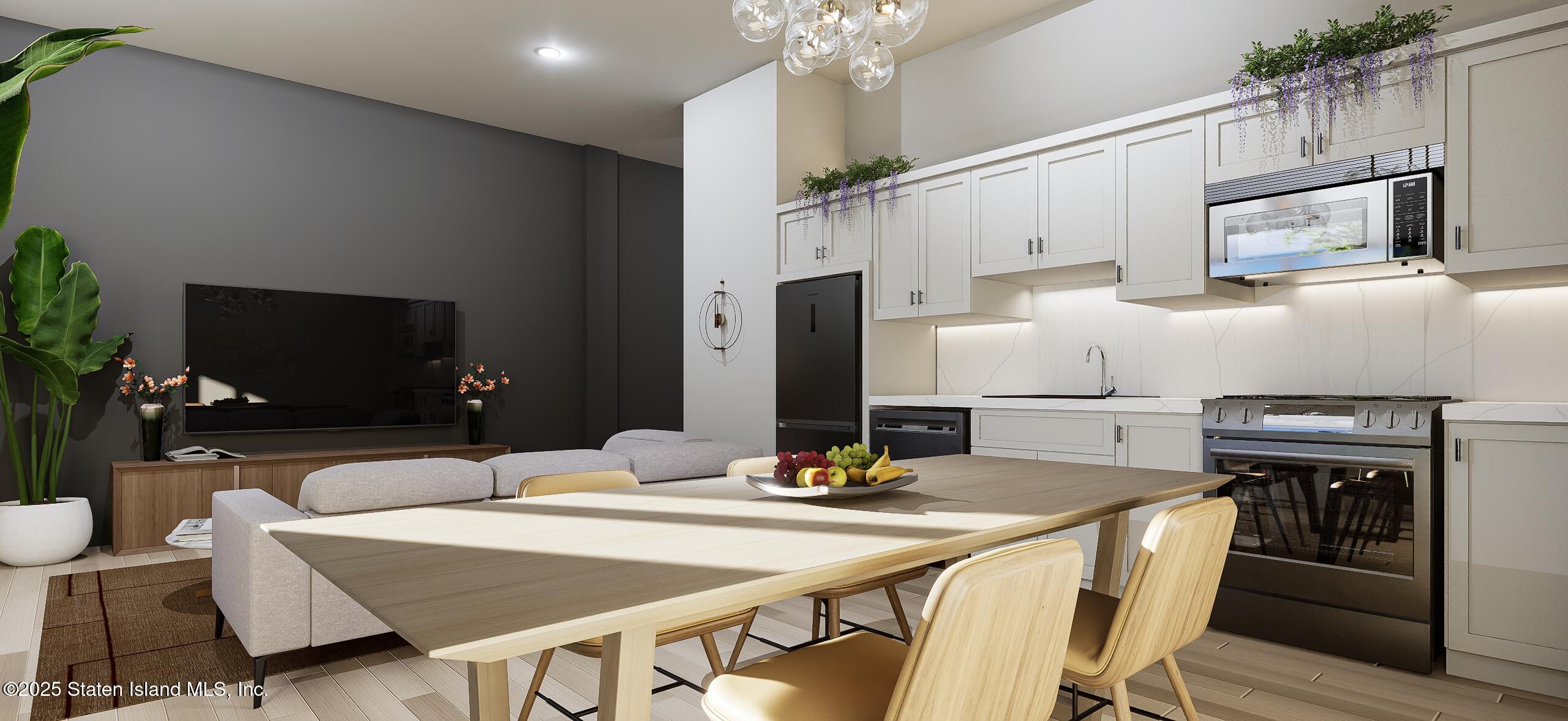 1239 Forest Hill Road, Unit 15 Staten Island, NY 10314 - Photo 7 of 15 a kitchen with stainless steel appliances kitchen island granite countertop a dining table and chairs
