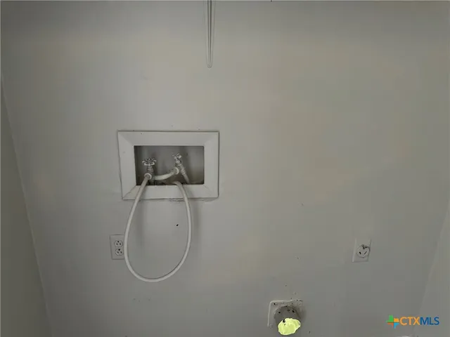 a kitchen with a sink cabinets and a window