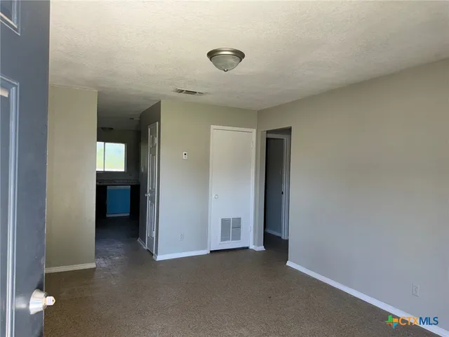 a kitchen with a refrigerator and cabinets