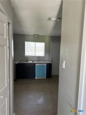 a kitchen with a refrigerator sink and stove