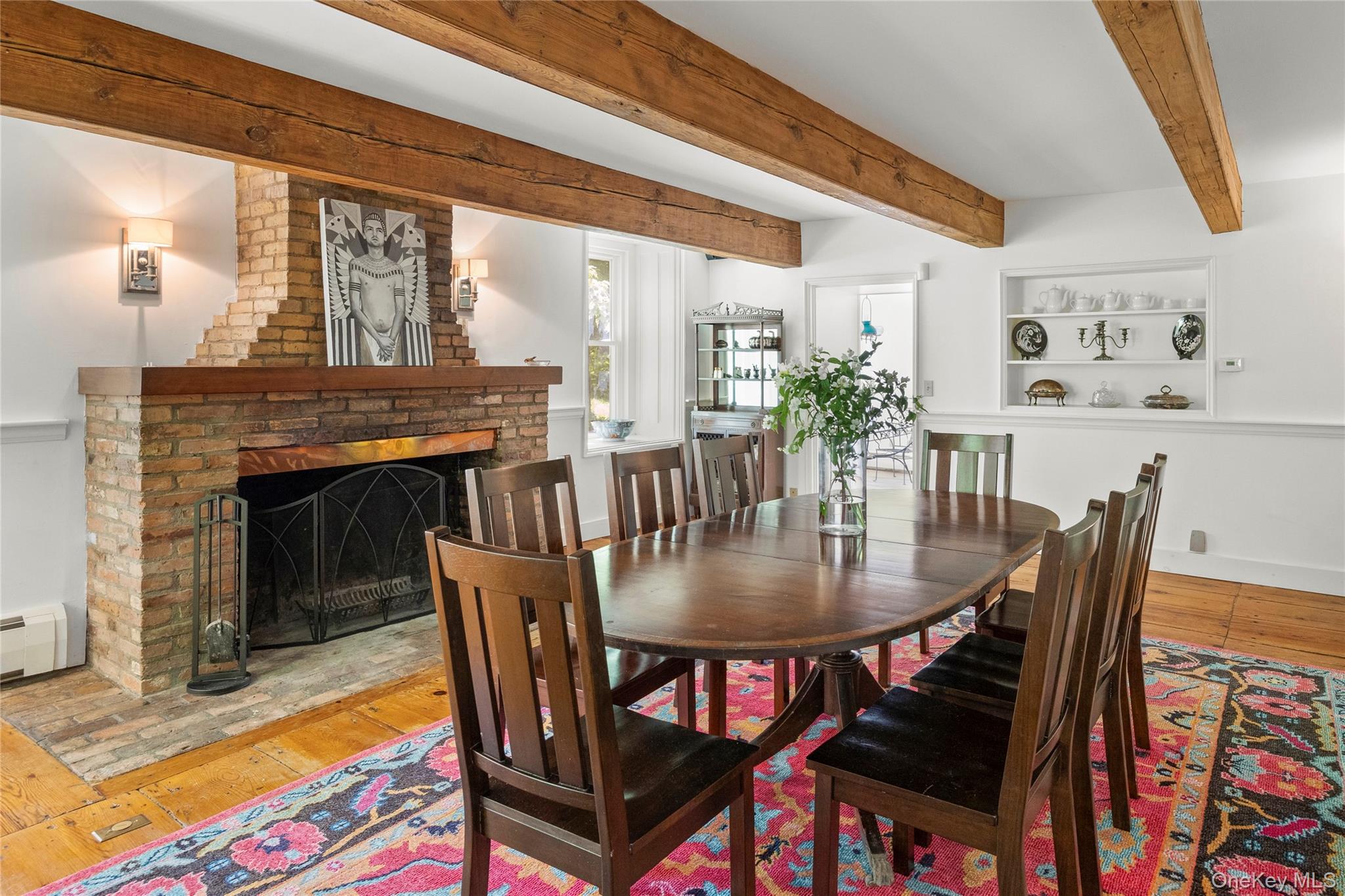 202 Buckwheat Road Hudson, NY 12534 - Photo 10 of 49 a dining room with furniture a rug a fireplace and a chandelier