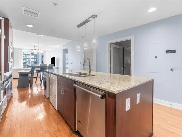 a large kitchen with lots of counter space and stainless steel appliances