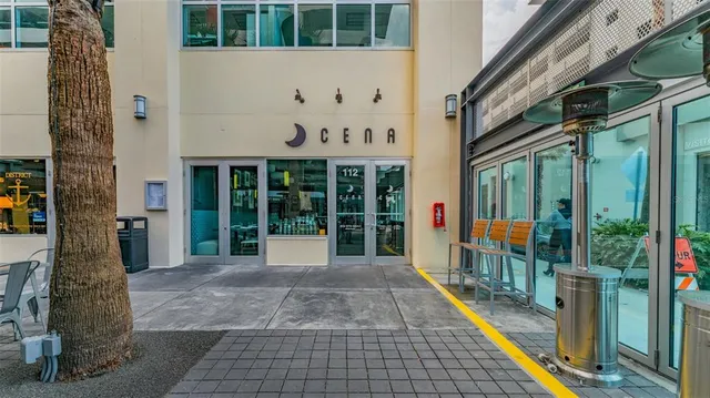 a front view of multi story residential apartment building with yard and traffic signal