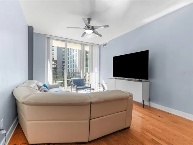 a living room with a flat screen tv and a large window