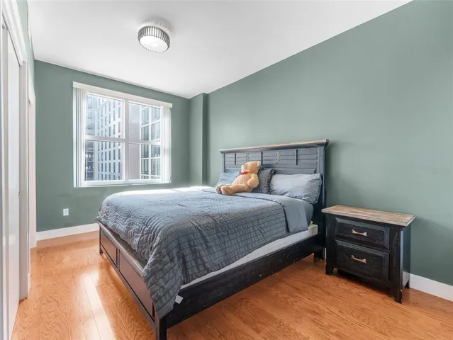 a bed sitting in a bedroom next to a window