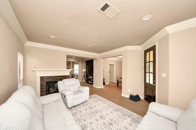 a living room with furniture a fireplace and a rug