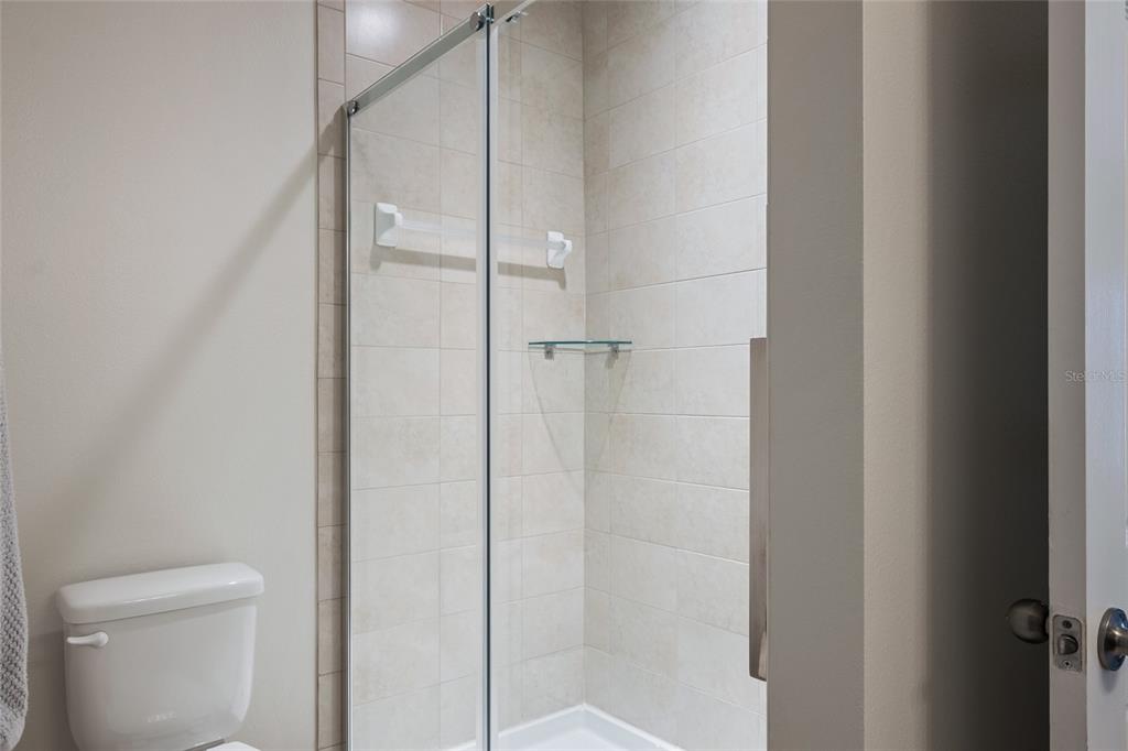 19041 Alfaro Loop Spring Hill, FL 34610 - Photo 13 of 39 a bathroom with a glass shower door