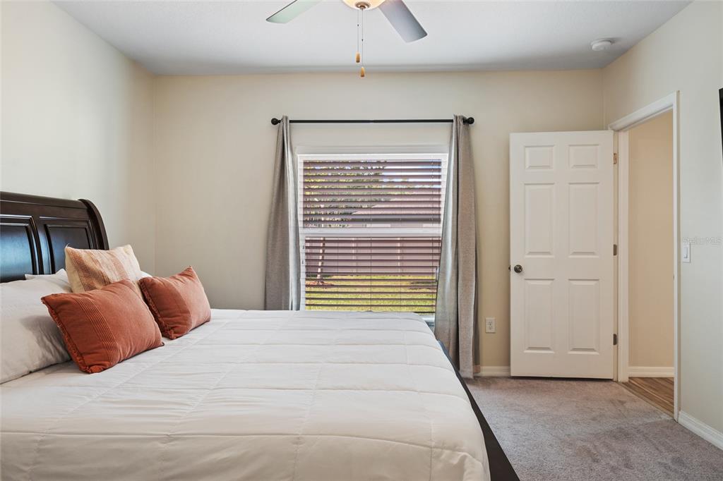 19041 Alfaro Loop Spring Hill, FL 34610 - Photo 15 of 39 a bedroom with a bed and a chandelier