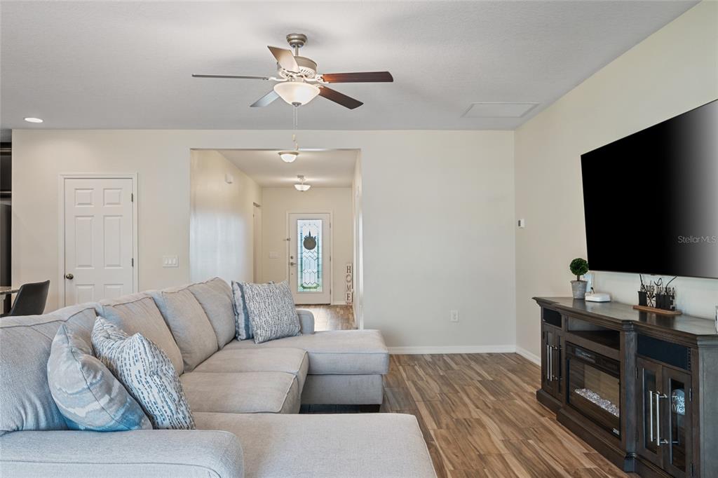 19041 Alfaro Loop Spring Hill, FL 34610 - Photo 16 of 39 a living room with furniture and a flat screen tv