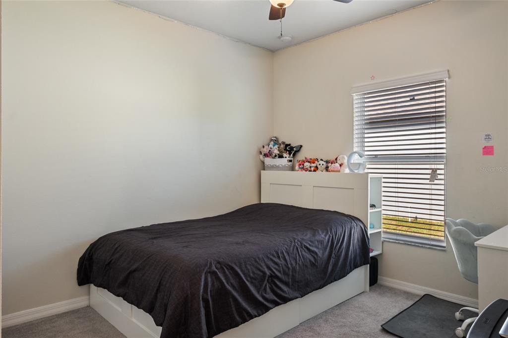 19041 Alfaro Loop Spring Hill, FL 34610 - Photo 18 of 39 a bedroom with a bed and a window