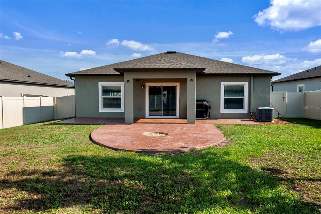 19041 Alfaro Loop Spring Hill, FL 34610 - Photo 23 of 39 a backyard of a house with table and chairs