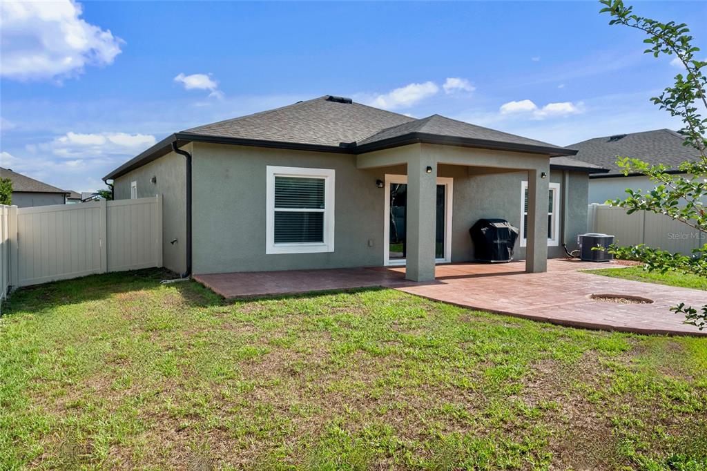 19041 Alfaro Loop Spring Hill, FL 34610 - Photo 25 of 39 a view of a house with a yard and garage