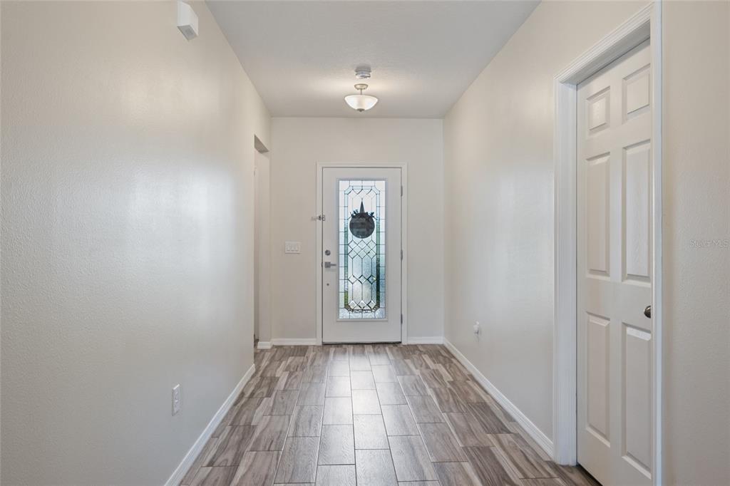 19041 Alfaro Loop Spring Hill, FL 34610 - Photo 3 of 39 a view of a hallway with wooden floor