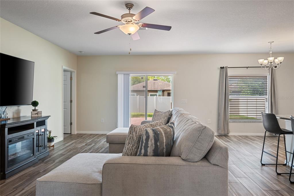 19041 Alfaro Loop Spring Hill, FL 34610 - Photo 8 of 39 a living room with furniture and a flat screen tv