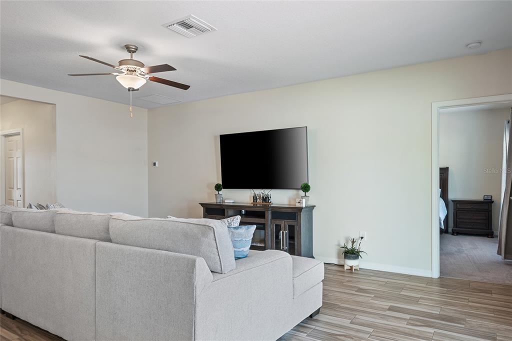 19041 Alfaro Loop Spring Hill, FL 34610 - Photo 9 of 39 a living room with furniture and a flat screen tv