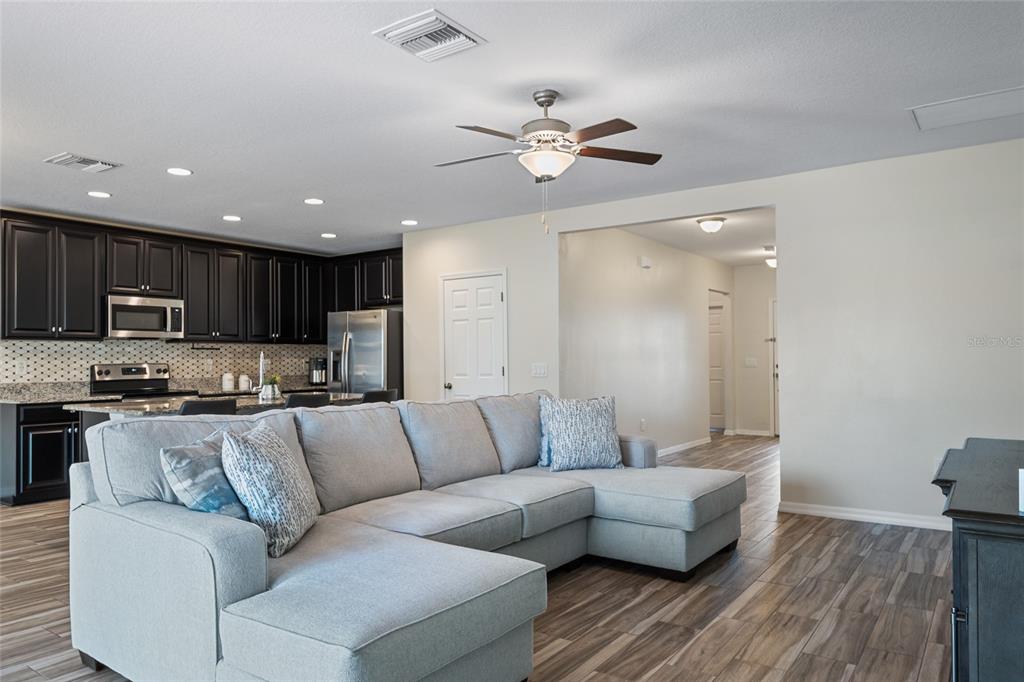 19041 Alfaro Loop Spring Hill, FL 34610 - Photo 10 of 39 a living room with furniture and kitchen view