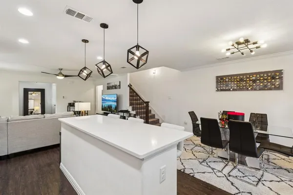 a view of a dining room with furniture and chandelier
