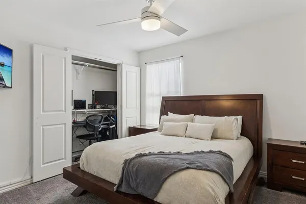 a bedroom with a bed and a chandelier