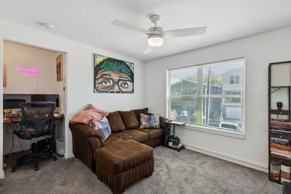 a living room with furniture and a large window