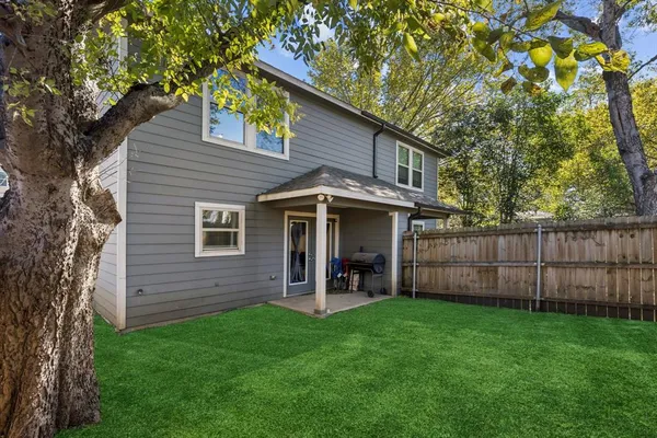 a view of an house with backyard space and garden