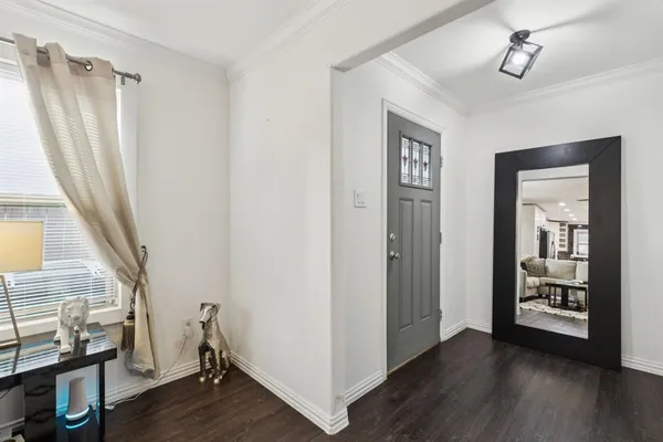 a view of a livingroom with wooden floor and a ceiling fan