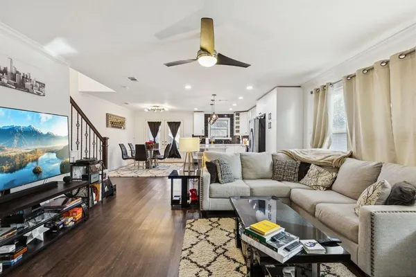 a living room with furniture and wooden floor