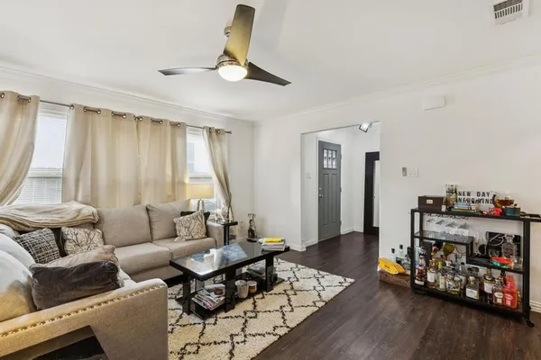 a living room with furniture and wooden floor
