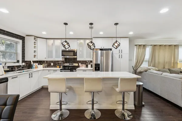 a large kitchen with a table and chairs