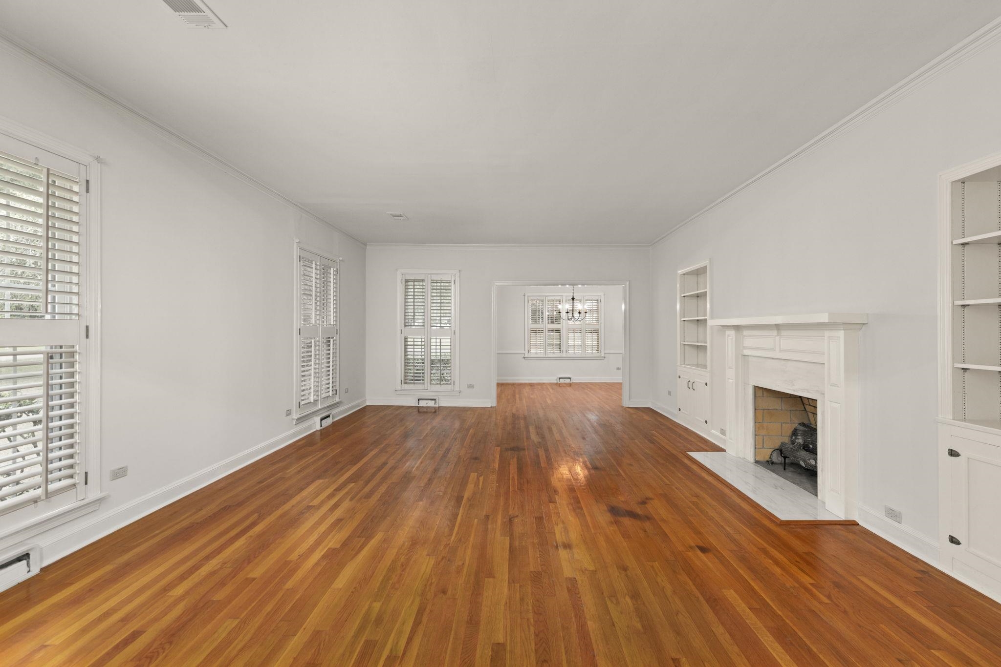 1906 Willow Road Corinth, MS 38834 - Photo 3 of 40 an empty room with wooden floor fireplace and windows