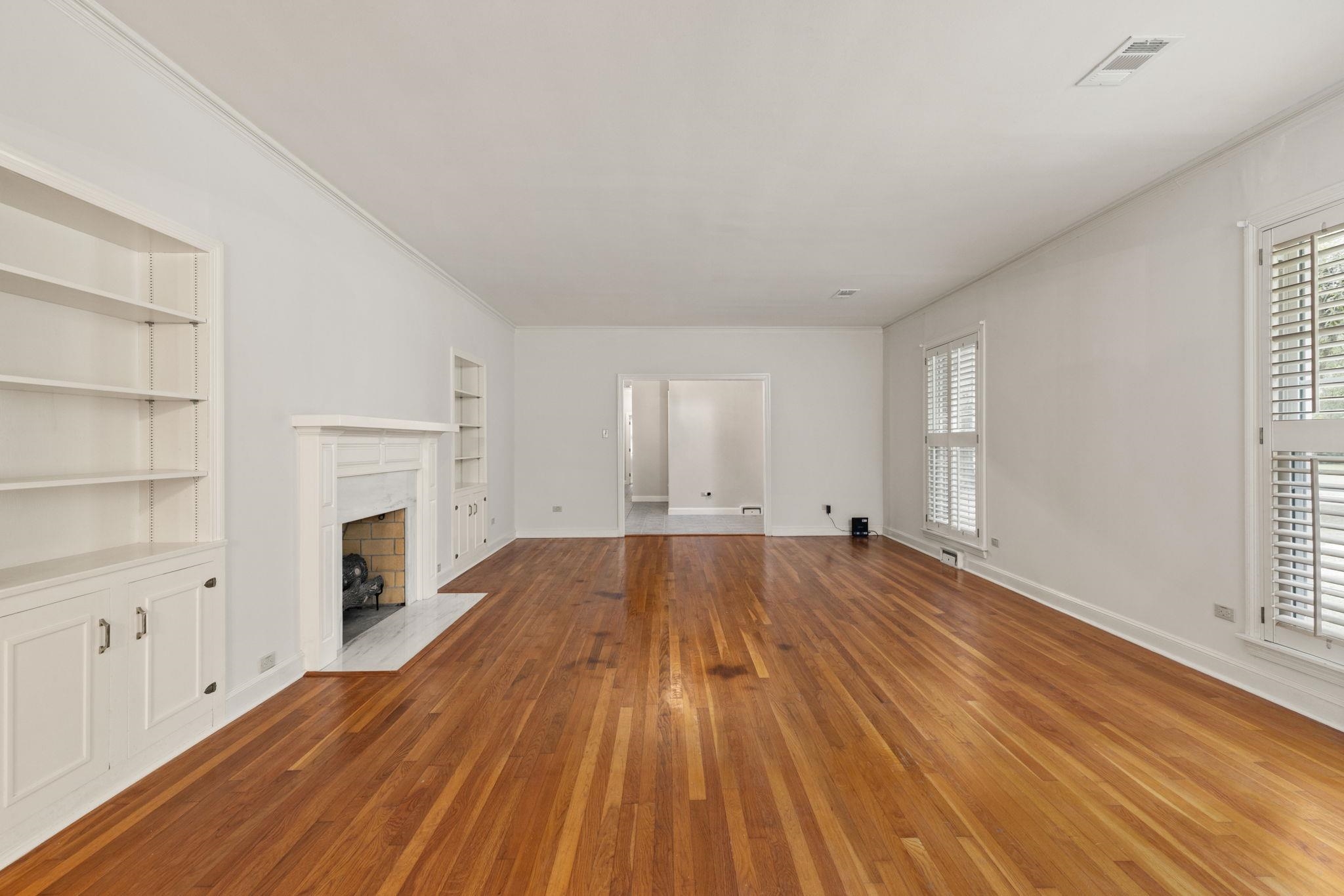 1906 Willow Road Corinth, MS 38834 - Photo 5 of 40 wooden floor in an empty room with a fireplace