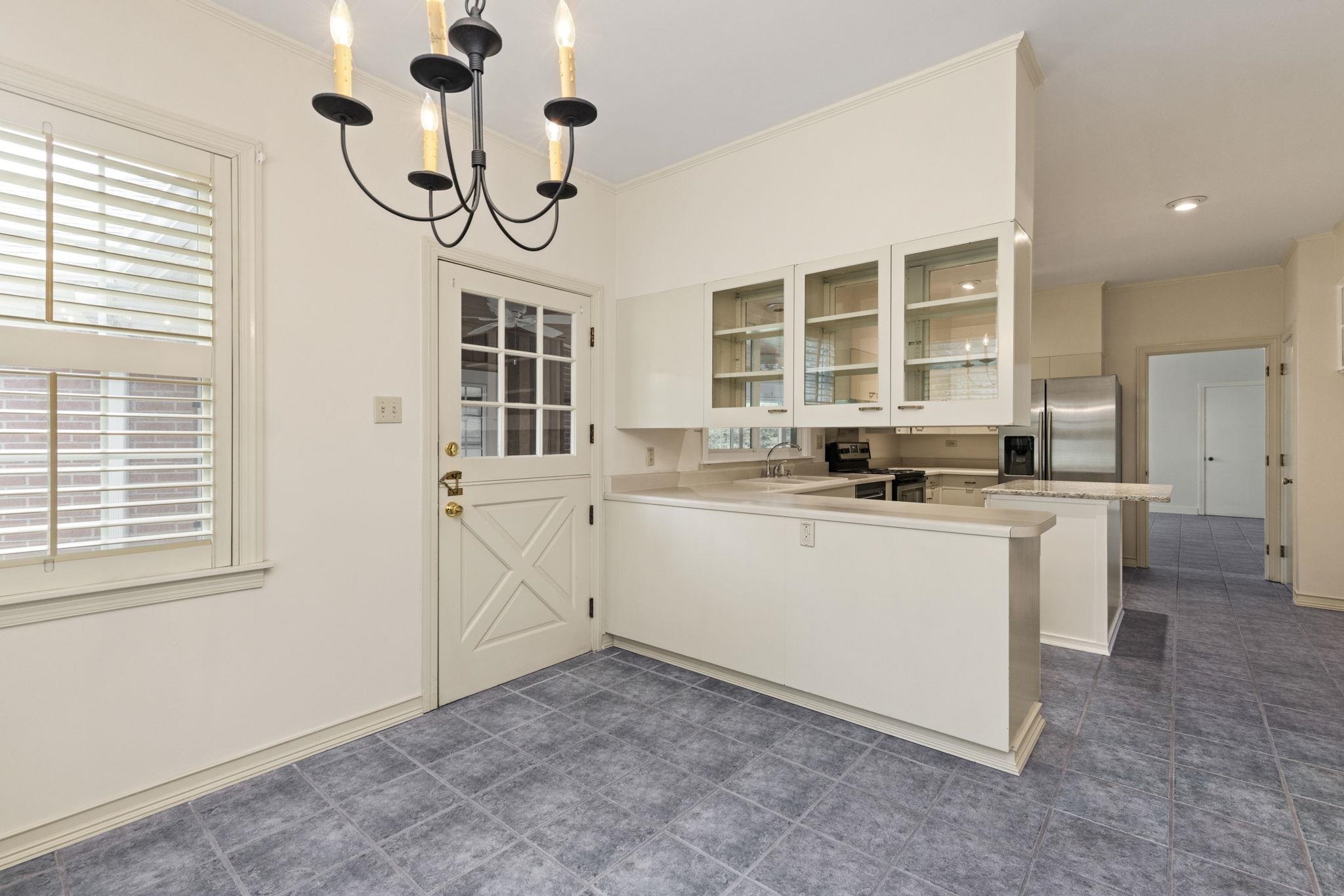 1906 Willow Road Corinth, MS 38834 - Photo 9 of 40 a kitchen with a refrigerator and white cabinets