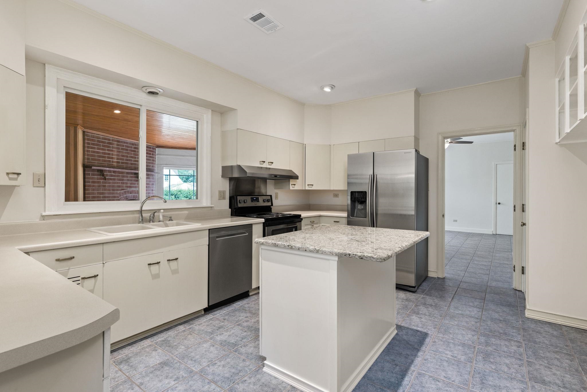 1906 Willow Road Corinth, MS 38834 - Photo 10 of 40 a kitchen with a sink stove and refrigerator