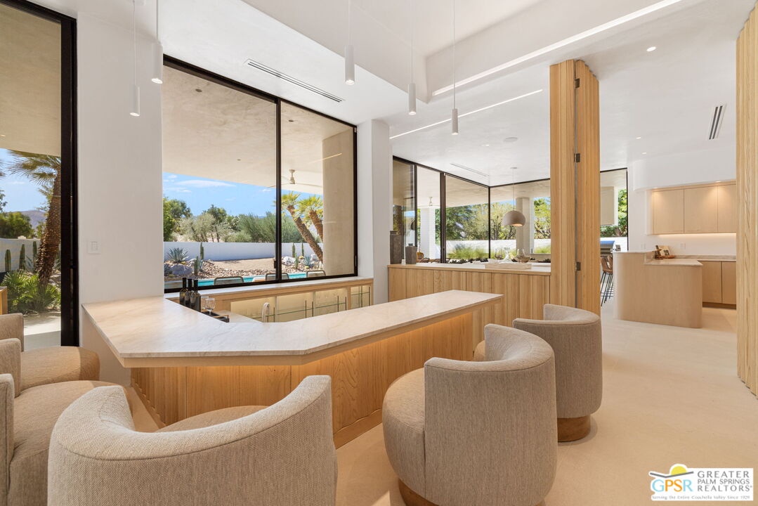 71000 Tamarisk Lane Rancho Mirage, CA 92270 - Photo 24 of 58 a living room with furniture and a large window