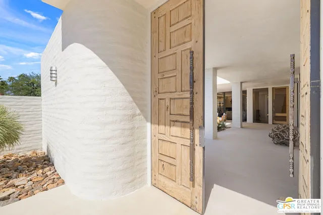 a view of a house with swimming pool and sitting area