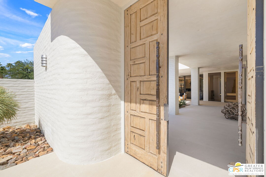 71000 Tamarisk Lane Rancho Mirage, CA 92270 - Photo 4 of 58 a view of a hallway with wooden floor and a living room