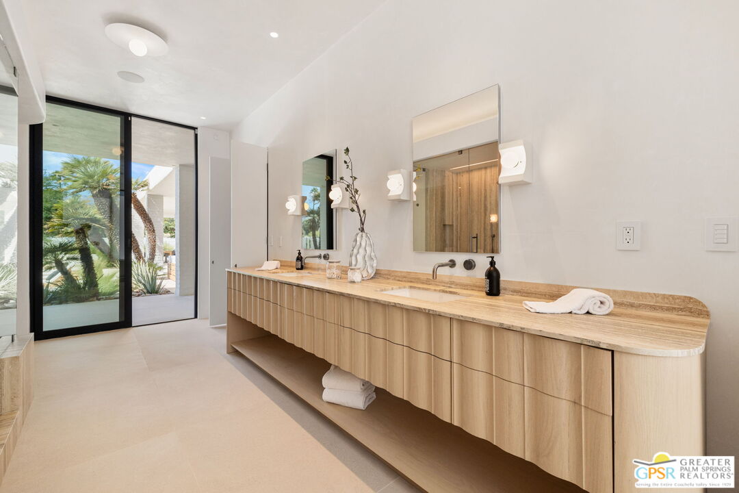 71000 Tamarisk Lane Rancho Mirage, CA 92270 - Photo 43 of 58 a bathroom with a double vanity sink and a large mirror