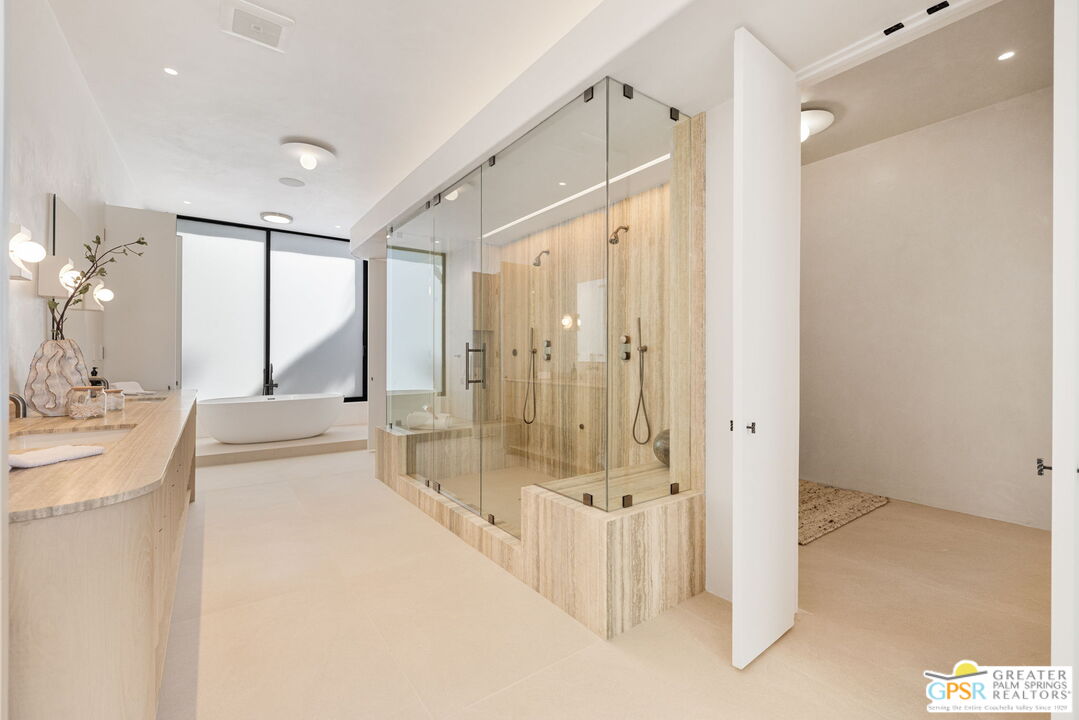 71000 Tamarisk Lane Rancho Mirage, CA 92270 - Photo 45 of 58 a spacious bathroom with a tub shower and sink