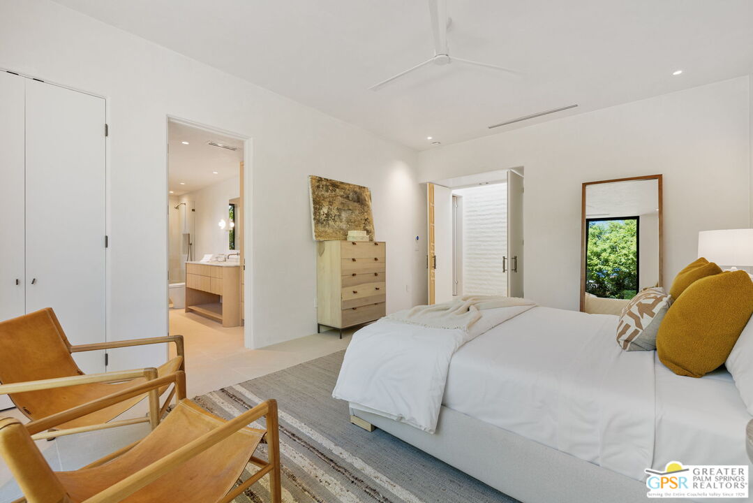 71000 Tamarisk Lane Rancho Mirage, CA 92270 - Photo 49 of 58 a spacious bedroom with a bed and wooden floor