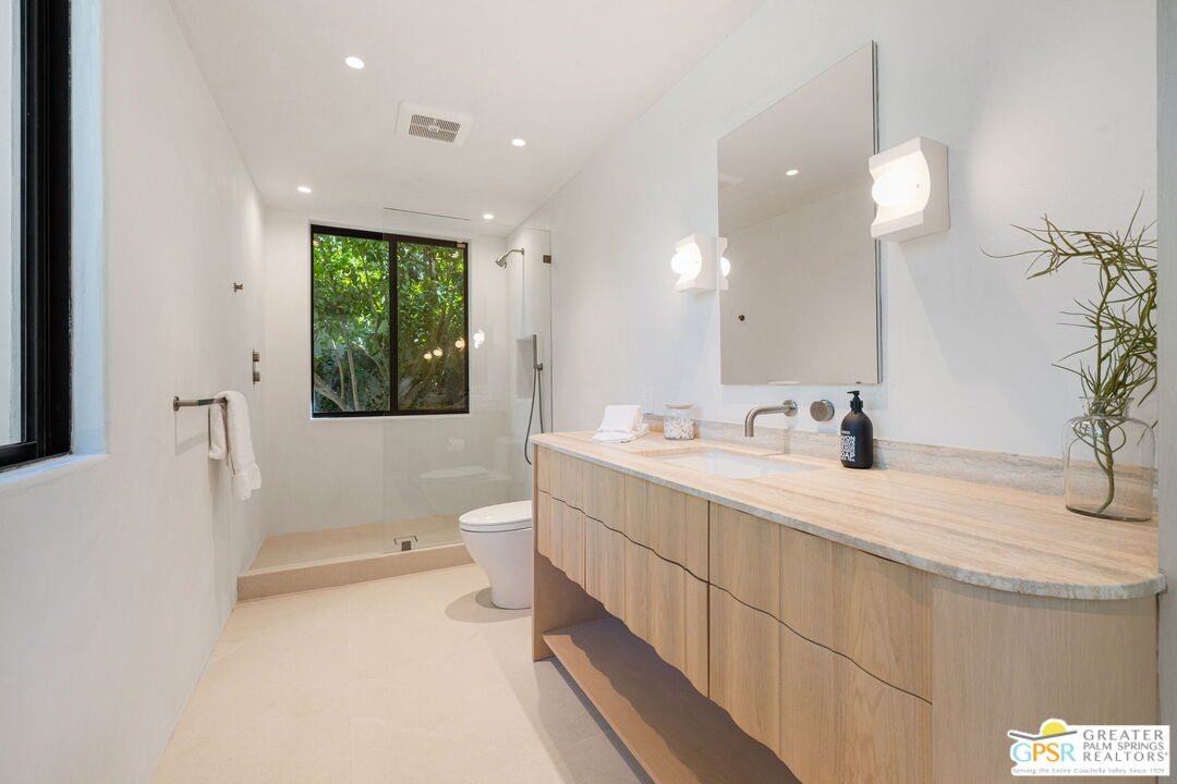 71000 Tamarisk Lane Rancho Mirage, CA 92270 - Photo 50 of 58 a spacious bathroom with a double vanity sink a mirror and a bathtub