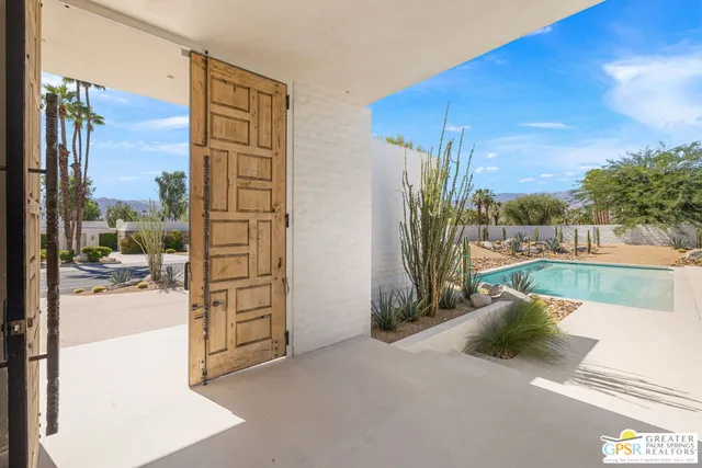 a view of a backyard with swimming pool