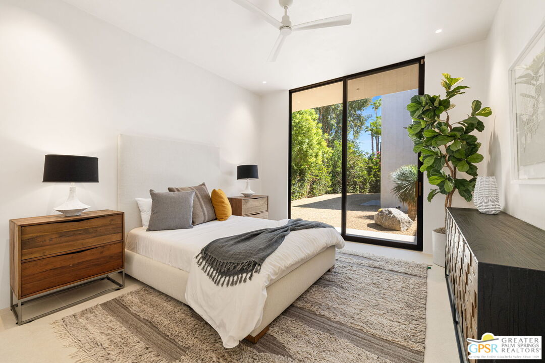 71000 Tamarisk Lane Rancho Mirage, CA 92270 - Photo 51 of 58 a bedroom with a large bed and a flat tv screen on dresser