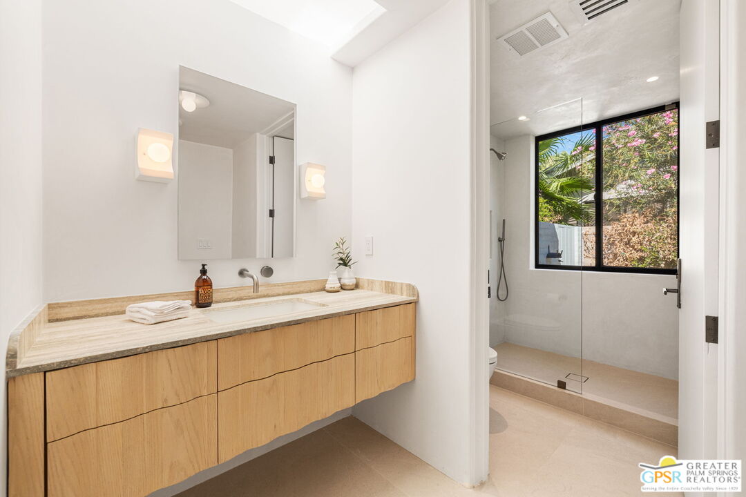 71000 Tamarisk Lane Rancho Mirage, CA 92270 - Photo 52 of 58 a bathroom with a sink and a mirror