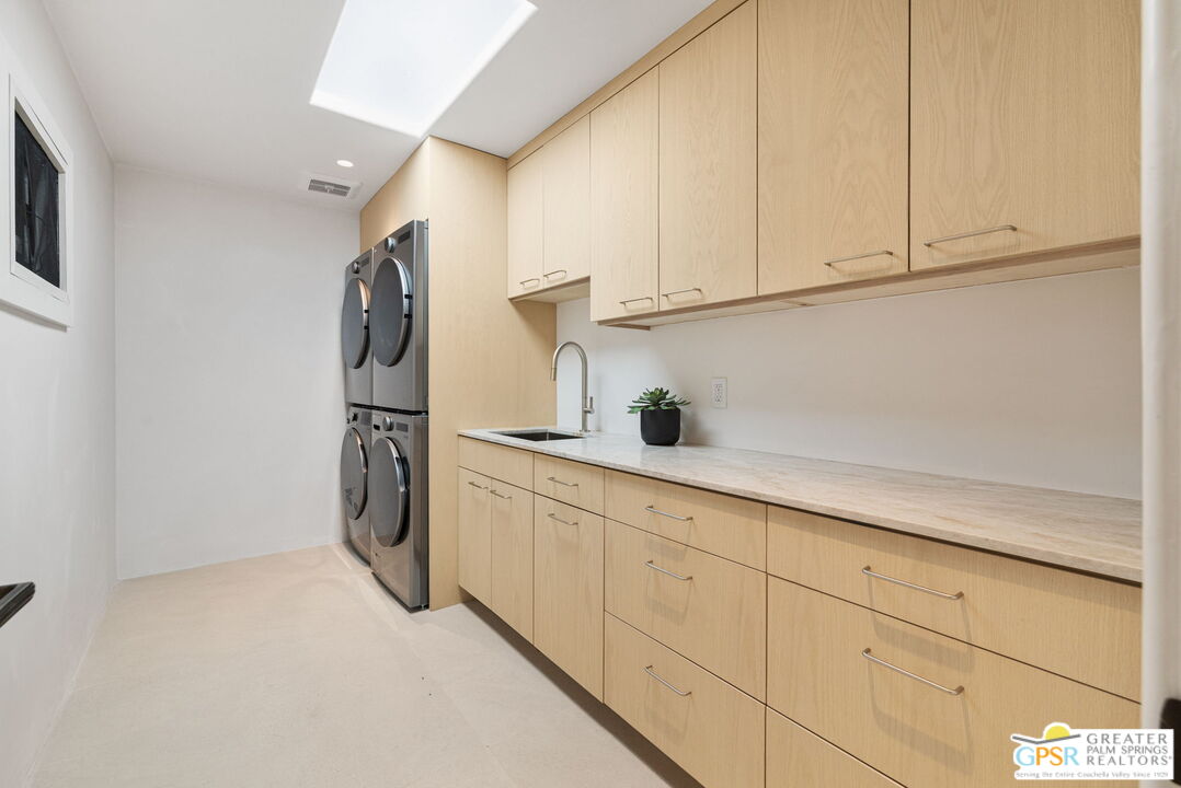 71000 Tamarisk Lane Rancho Mirage, CA 92270 - Photo 57 of 58 a kitchen with cabinets and a refrigerator