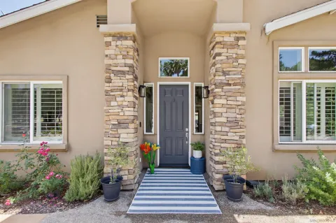 front view of a house with a potted plant
