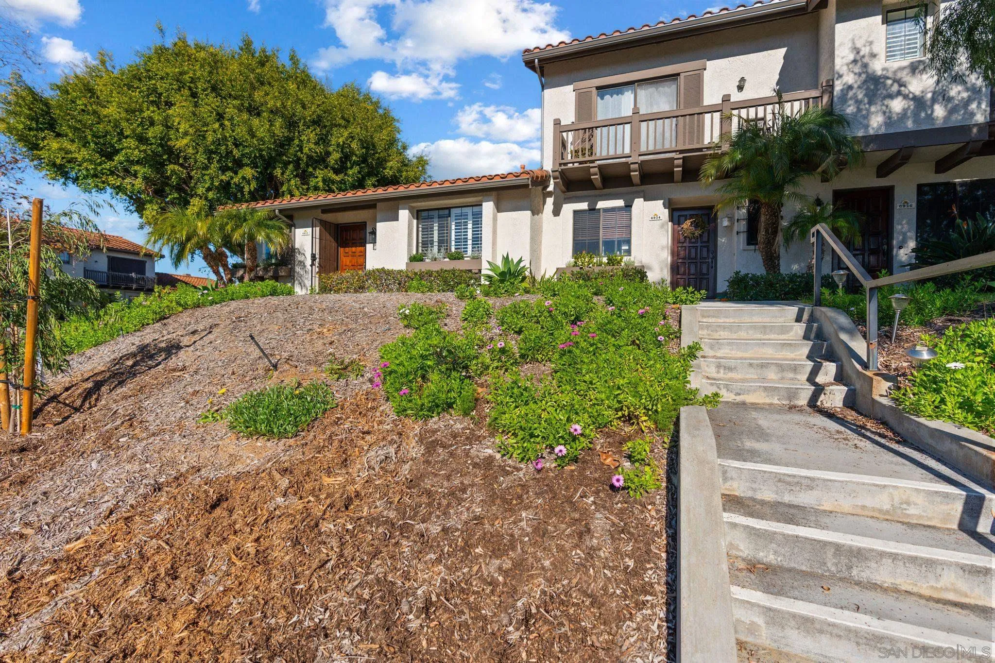 6922 Pear Tree Drive Carlsbad, CA 92011 - Photo 2 of 44 a front view of a house with garden