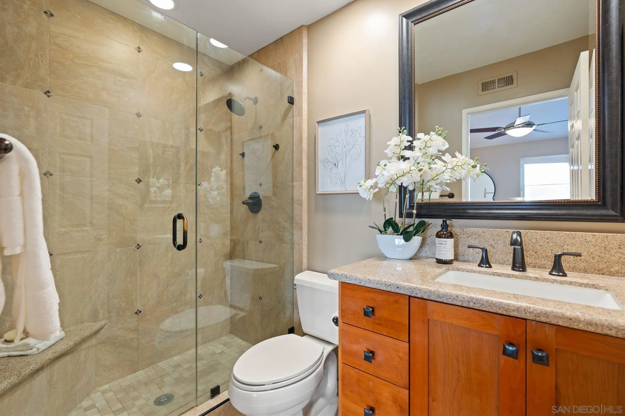 6922 Pear Tree Drive Carlsbad, CA 92011 - Photo 22 of 44 a bathroom with a granite countertop sink toilet and shower